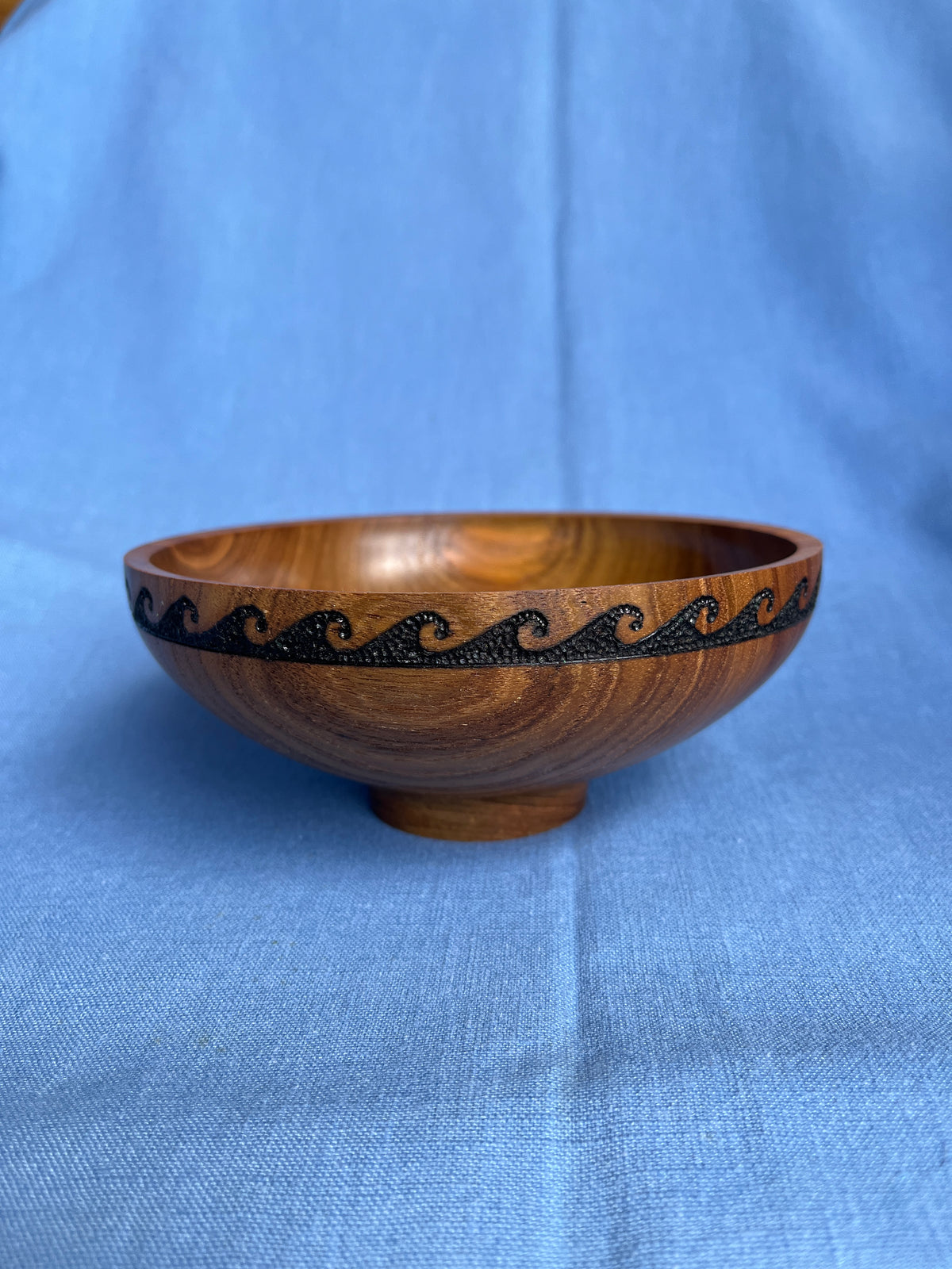 Craig Mason: Teak wood open bowl with a burned, textured wave pattern below the rim