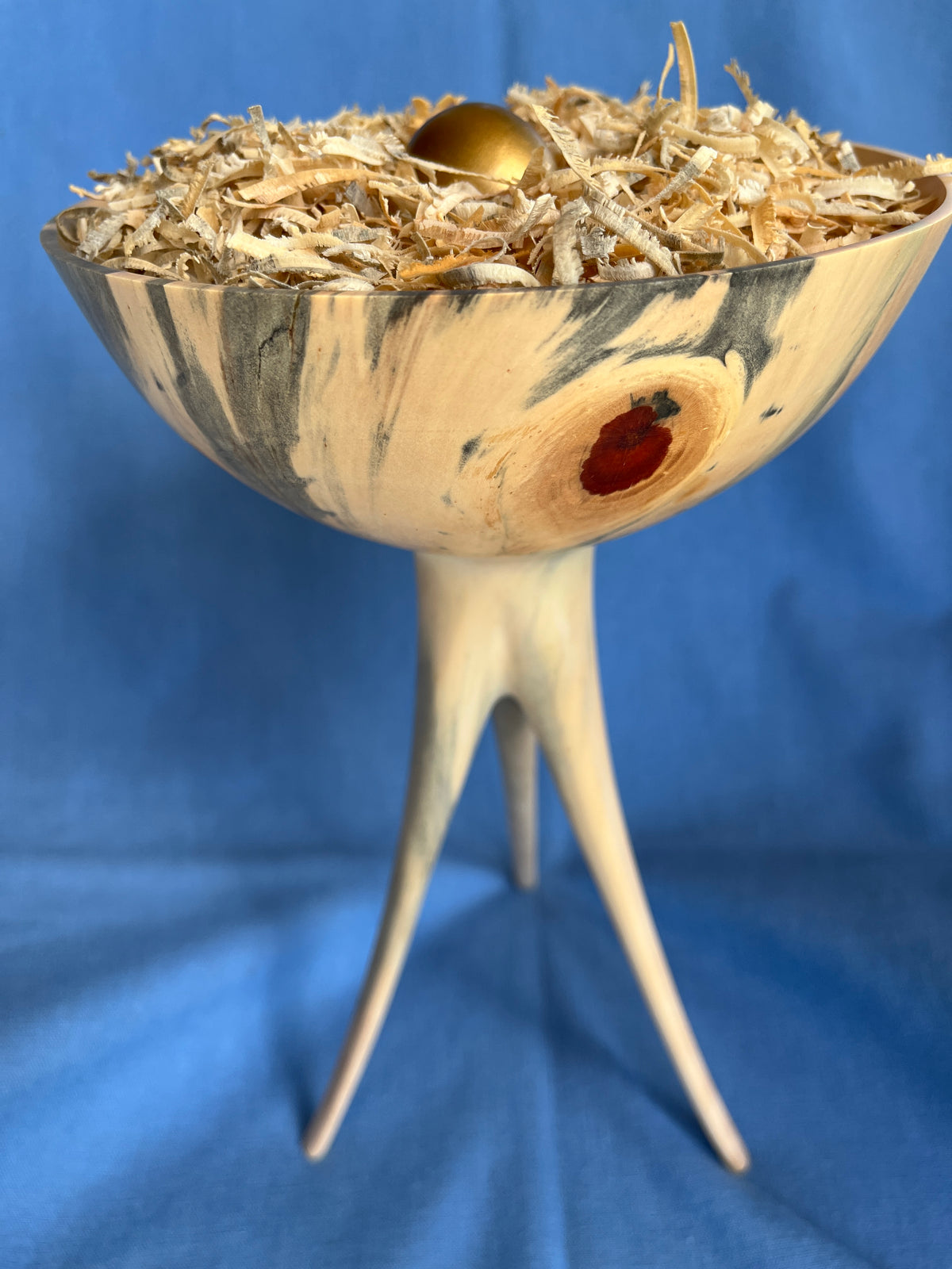 Craig Mason: Norfolk Island Pine bowl with five knots and three long slender legs.